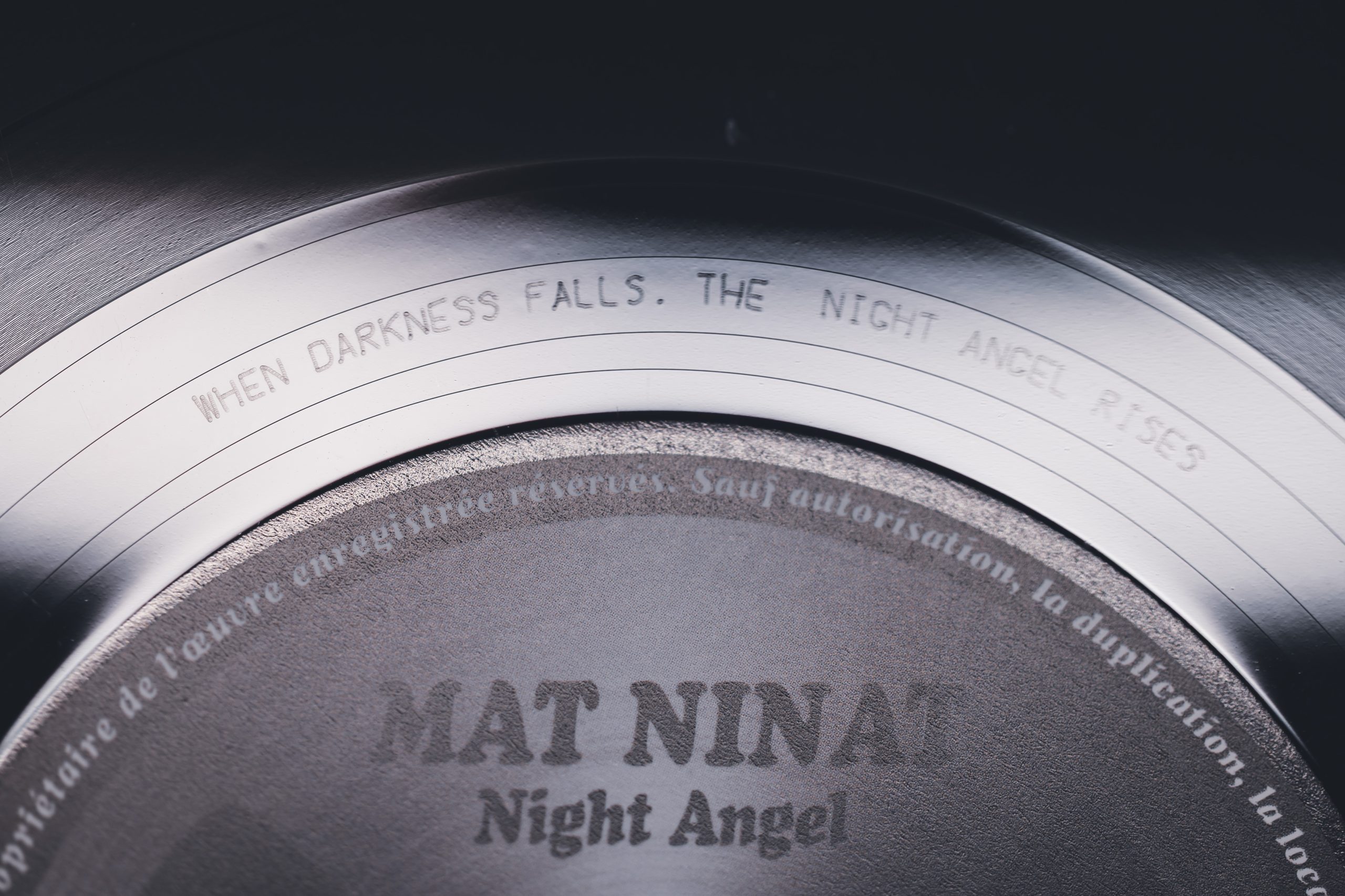Close-up of the vinyl runout groove engraving for ‘Night Angel’ album – ‘When Darkness Falls - the Night Angel Rises"